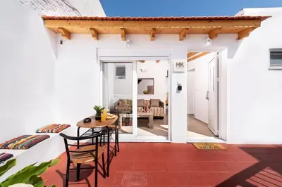 a room with a table and chairs and a living room at M&K Traditional House in Theologos