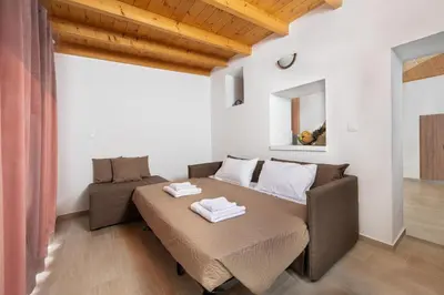 a living room with a bed and a couch at M&K Traditional House in Theologos