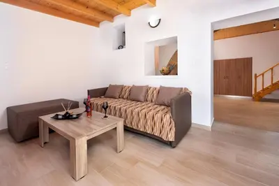 a living room with a couch and a table at M&K Traditional House in Theologos