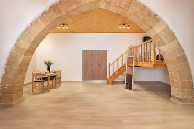 an archway in a room with a table and a staircase at M&K Traditional House in Theologos