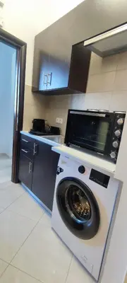a kitchen with a washing machine in a kitchen at Archangelos SKY Junior Apartment in Archangelos