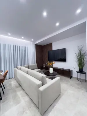 a living room with a couch and a flat screen tv at AleNi City Apartment 1 in Rhodes Town