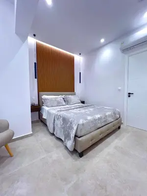a bedroom with a large bed in a white room at AleNi City Apartment 1 in Rhodes Town
