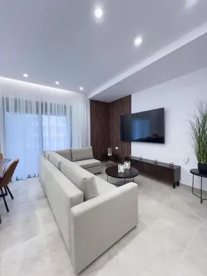 a living room with a couch and a flat screen tv at AleNi City Apartment 2 in Rhodes Town
