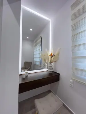 a room with a mirror and a vase with flowers at AleNi City Apartment 2 in Rhodes Town