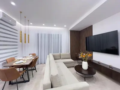 a living room with a white couch and a tv at AleNi City Apartment 2 in Rhodes Town