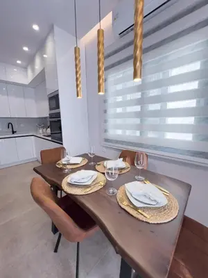 a dining room with a wooden table and chairs at AleNi City Apartment 2 in Rhodes Town