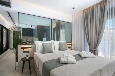 a bedroom with two white towels on a bed at Karma Luxury Suites in Rhodes Town