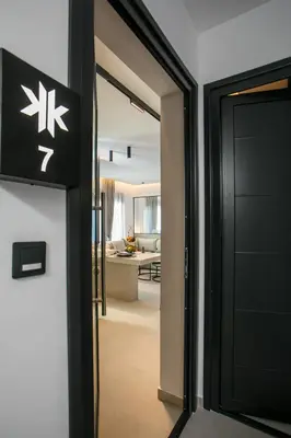 an open door to a room with a living room at Karma Luxury Suites in Rhodes Town