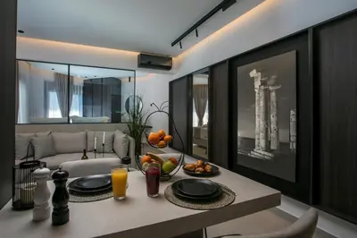 a living room with a table with a bowl of fruit at Karma Luxury Suites in Rhodes Town