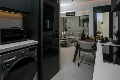 a kitchen and a living room with a dishwasher at Karma Luxury Suites in Rhodes Town