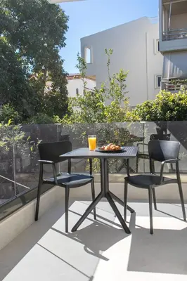a table and two chairs sitting on a balcony at Karma Luxury Suites in Rhodes Town
