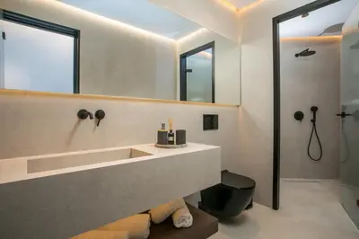 a bathroom with a sink and a mirror at Karma Luxury Suites in Rhodes Town