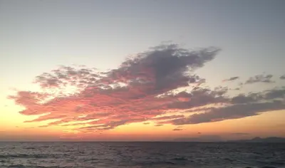 a sunset over the ocean with a cloudy sky at 4 Brothers in Rhodes Town