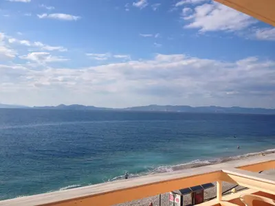 a view of the ocean from a balcony of a beach at 4 Brothers in Rhodes Town