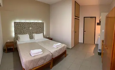 a bedroom with a bed with two towels on it at 4 Brothers in Rhodes Town