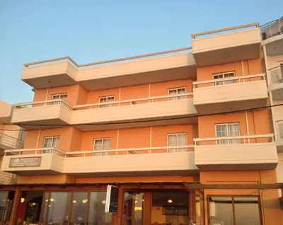 an orange building with balconies on it at 4 Brothers in Rhodes Town