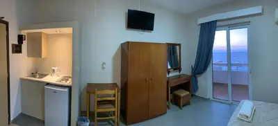 a hotel room with a sink and a desk with a mirror at 4 Brothers in Rhodes Town