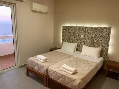 a bedroom with a bed with two towels on it at 4 Brothers in Rhodes Town