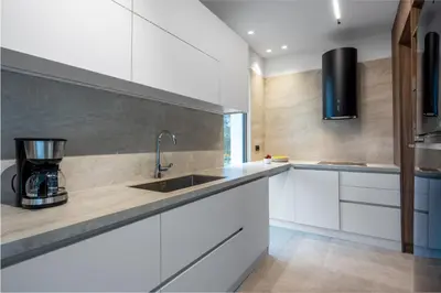a kitchen with white cabinets and a sink at Casa Yiava in Ialyssos