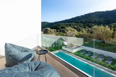 a room with a balcony with a swimming pool at Casa Yiava in Ialyssos