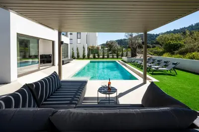 a patio with a couch and a swimming pool at Casa Yiava in Ialyssos