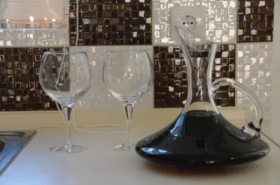 three wine glasses sitting on top of a counter at Next to Haraki beach , taverns bars & 10 to Lindos in Haraki