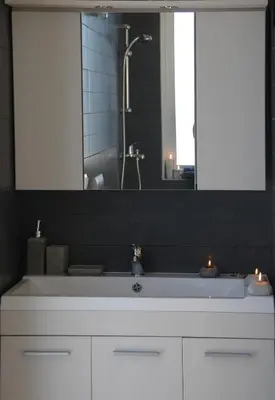 a bathroom sink with two candles and a mirror at Next to Haraki beach , taverns bars & 10 to Lindos in Haraki