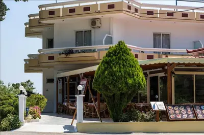 a building with a tree in front of it at Aphrodite Apartments in Kallithea Rhodes