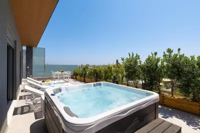 a hot tub on the balcony of a house at Rhodes Skyline Suite with out Door Jacuzzi Sea View A2 in Ixia