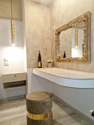 a bathroom with a large mirror and a stool at Golden City Center Suites in Rhodes Town
