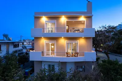 a large white house with a balcony at night at Atelier 71 in Rhodes Town