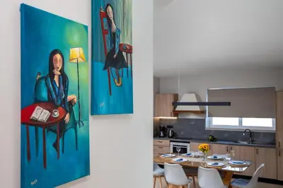 a kitchen and dining room with a painting on the wall at Atelier 71 in Rhodes Town