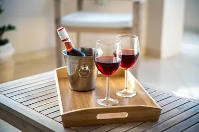 two glasses of wine sitting on a wooden tray at Atelier 71 in Rhodes Town