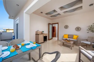 a living room with a table and chairs at Atelier 71 in Rhodes Town