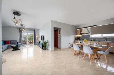 a kitchen and dining room with a table and chairs at Atelier 71 in Rhodes Town