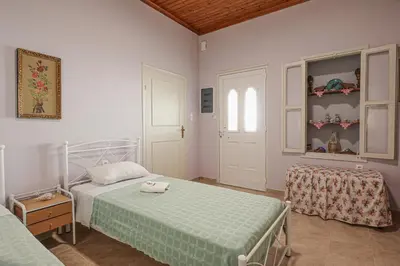 a bedroom with two beds and a window at Aneza in Kremasti