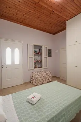 a bedroom with a large bed and a couch at Aneza in Kremasti