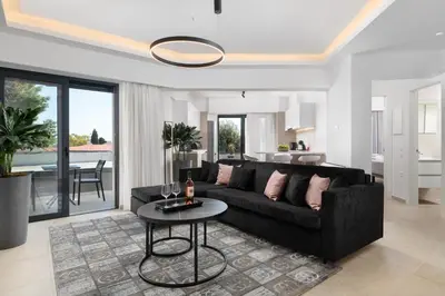 a living room with a black couch and a table at K Luxury Apartment in Rhodes Town