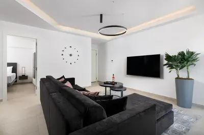 a living room with a couch and a tv at K Luxury Apartment in Rhodes Town