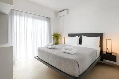 a bedroom with a large bed with towels on it at K Luxury Apartment in Rhodes Town