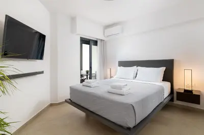 a bedroom with a bed with two towels on it at K Luxury Apartment in Rhodes Town