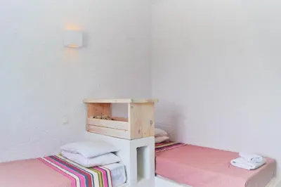 a small room with a bed and a small table with towels at Hotel Irini in Livadia
