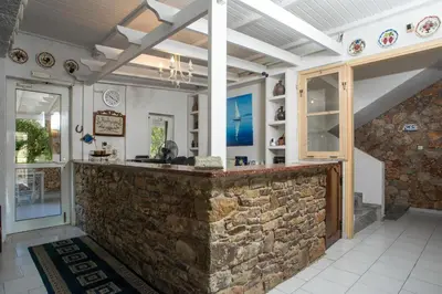 a stone bar in a room with a stone wall at Hotel Irini in Livadia