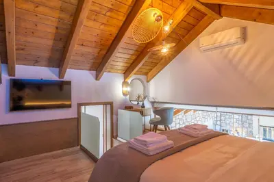 a bedroom with a large bed in a room with wooden ceilings at Rhode Luxury Villa in Kalithies