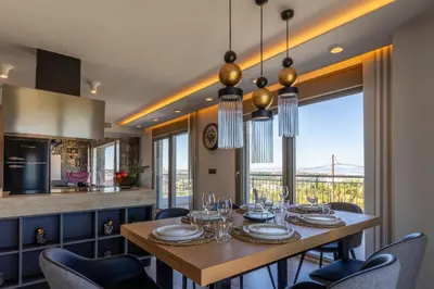 a kitchen and dining room with a table and chairs at Rhode Luxury Villa in Kalithies