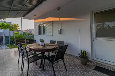 a wooden table and chairs on a patio at Beachside Apartment-2 in Afantou