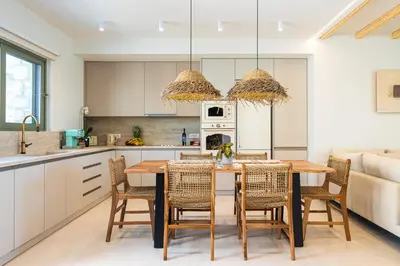 a kitchen with a dining room table and chairs at Sirin Luxury Suites - 1st floor in Haraki