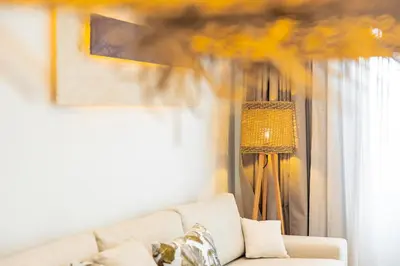 a living room with a couch and a lamp at Sirin Luxury Suites - 1st floor in Haraki
