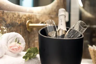 a black container with a brush and a bottle of champagne at Sirin Luxury Suites - 1st floor in Haraki